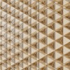 A close-up of a golden geometric pattern creating a stunning visual effect on a textured wall surface.